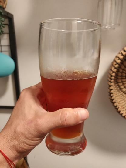 A beer glass filled with Paulaner Salvator in my left hand.