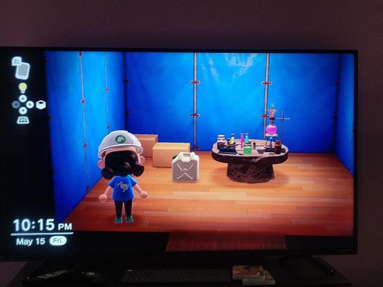 Animal Crossing screenshot showing the player wearing a gas mask standing in front of some plastic jugs and chemistry equipment. The walls of the room have a tarp texture implying it's some kind of improvised structure in a garage or outside or something