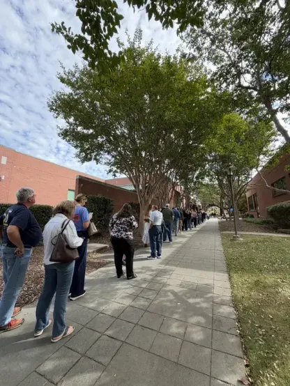 A long line of people under some trees and next to some buildings, stretching off into the distance

source: https://www.reddit.com/r/pics/comments/1xawic7/early_voting_today_in_north_dallas_oc/