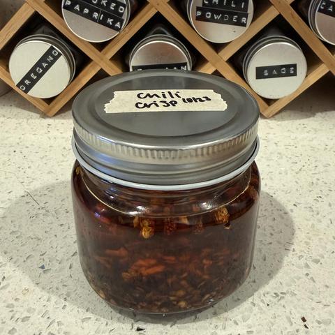 Jar of Maria's delicious homemade chili oil.