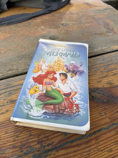 VHS tape of The Little Mermaid with the cover that was banned because they realized the artist drew penises on the castle.