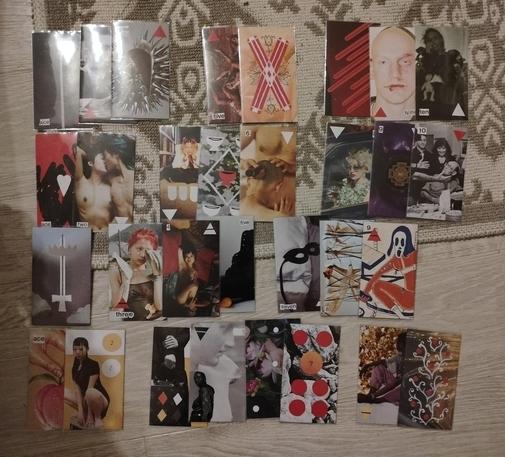 Handmade collaged tarot cards laid out in four rows representing the four suits. Each row has 2 or 3 gaps where a card should be